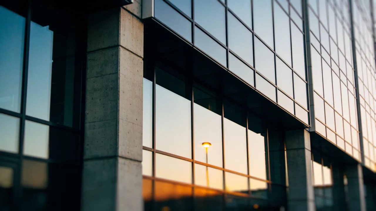 Photo: a logo-free modern fintech office exterior before an AI infrastructure acquisition